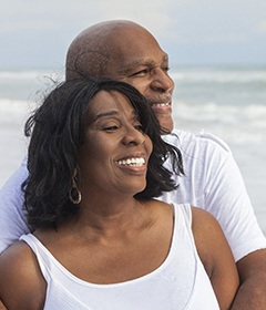 Couple smiling with dental implants in Oshkosh