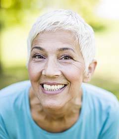 woman with dental implants in Freedom grinning from ear to ear 