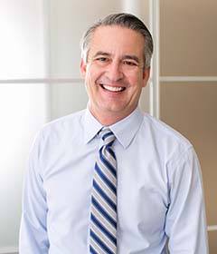 businessman in a tie smiling in his office 