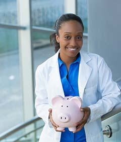 smiling dentist holding a pink piggy bank 