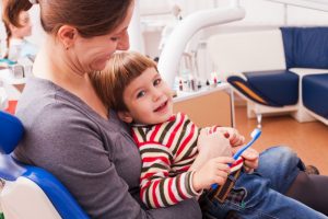 mother holding son dental visit