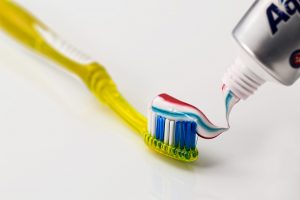 yellow toothbrush with toothpaste on it