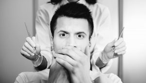 man looking scared at dentist 