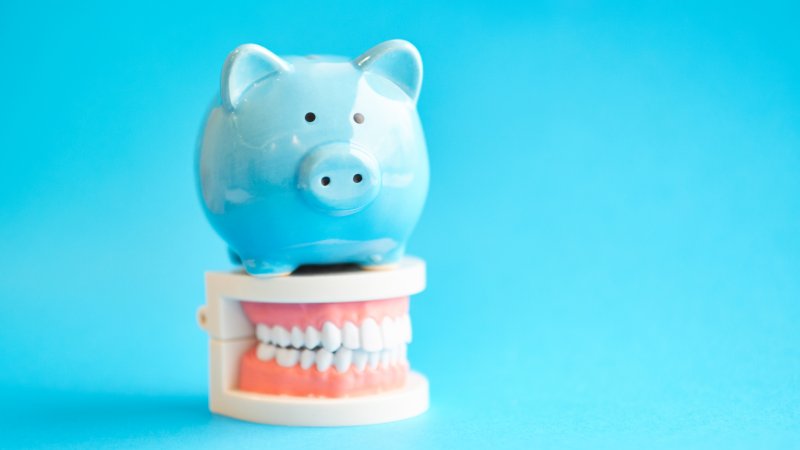 Piggy bank with model teeth.