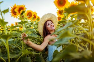 smiling woman flowers sun