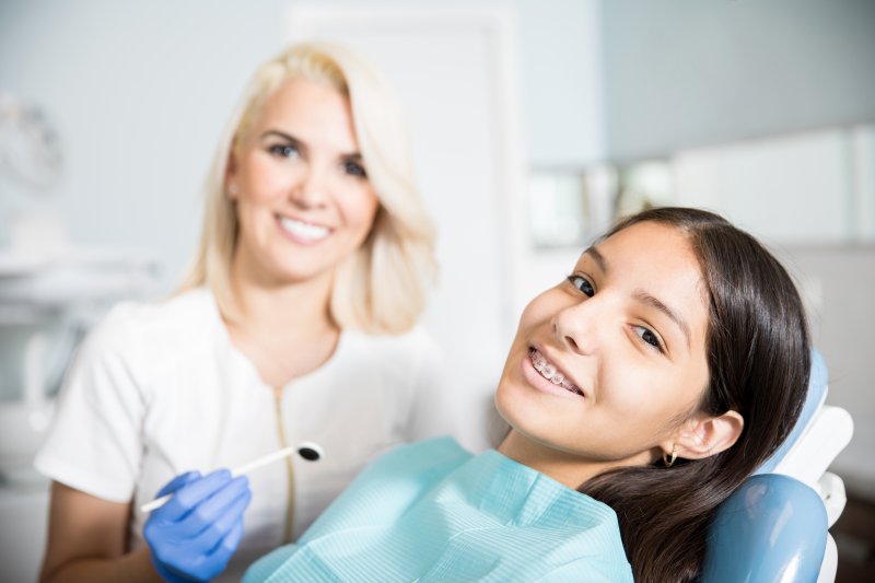 A teen girl about to have a dental exam with a dentist in Freedom