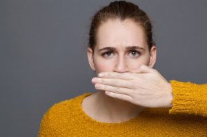 Woman covering her mouth with her hand