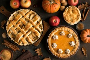 Pumpkin and apple pies sitting on an autumn table