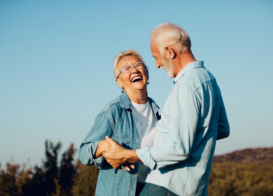 Older couple smiling and dancing