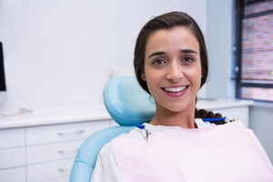 Woman sitting in dental chair smiling