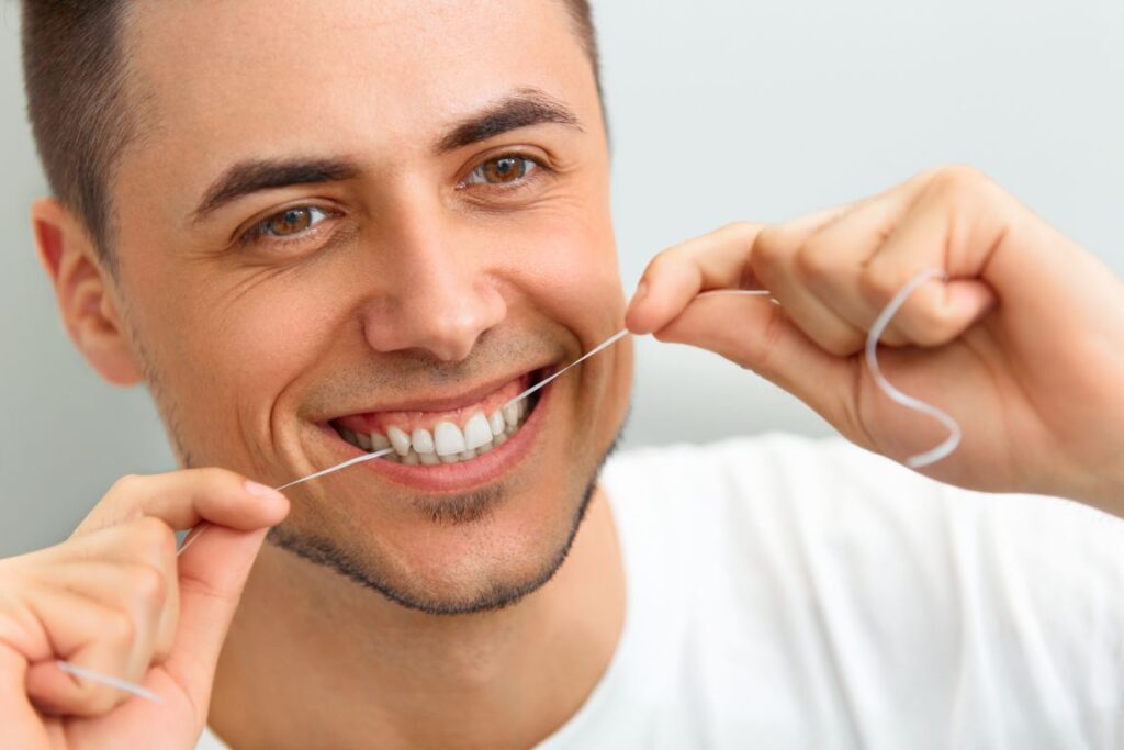 A man flossing his teeth