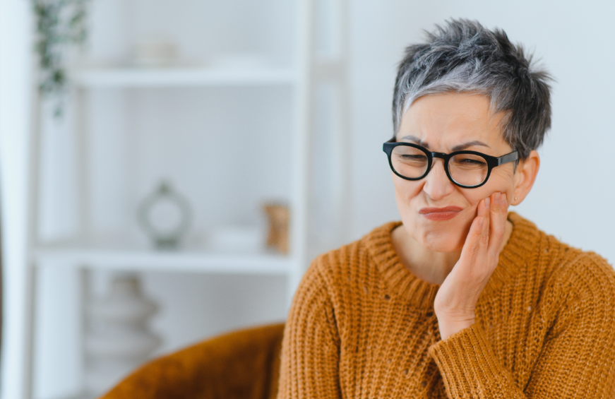 Woman holding jaw in pain