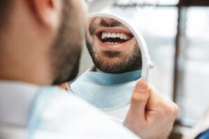 Man smiling into mirror
